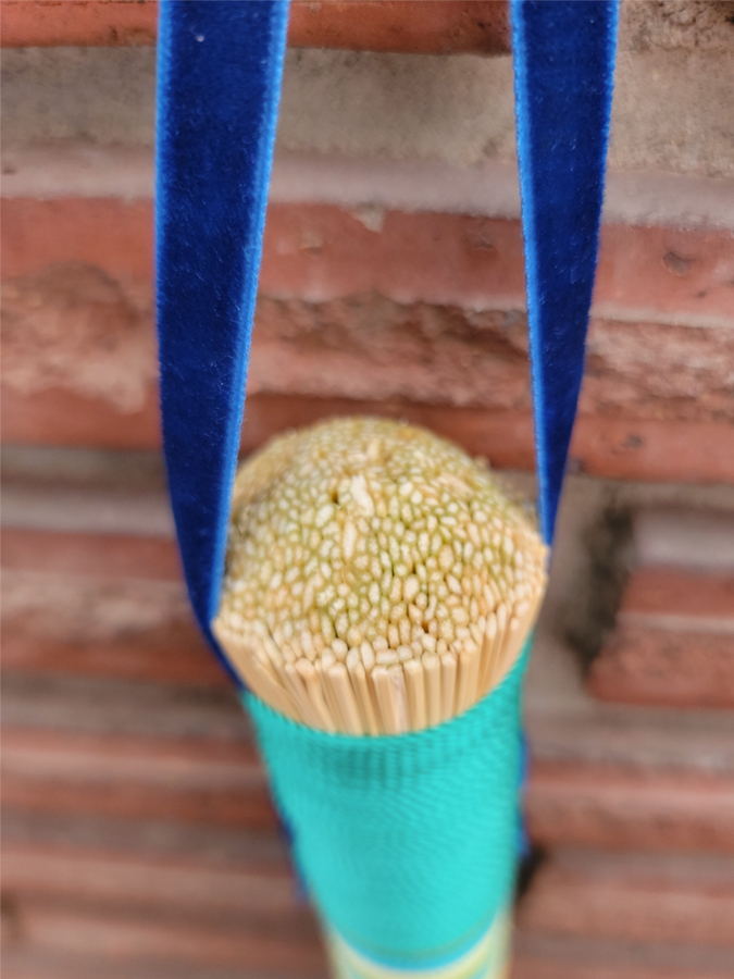End of broom is carved into a dome shape. Faux blue velvet hangtag