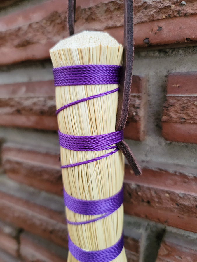 Detail of leather hangtag and purple weave