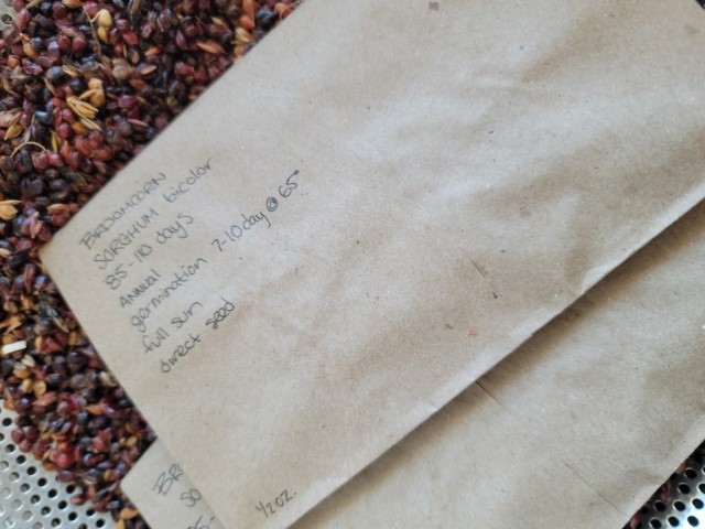 brown paper packaging of Broomcorn seeds with handwritten seed information - sorghum Bicolor from Sorghum & Leather
