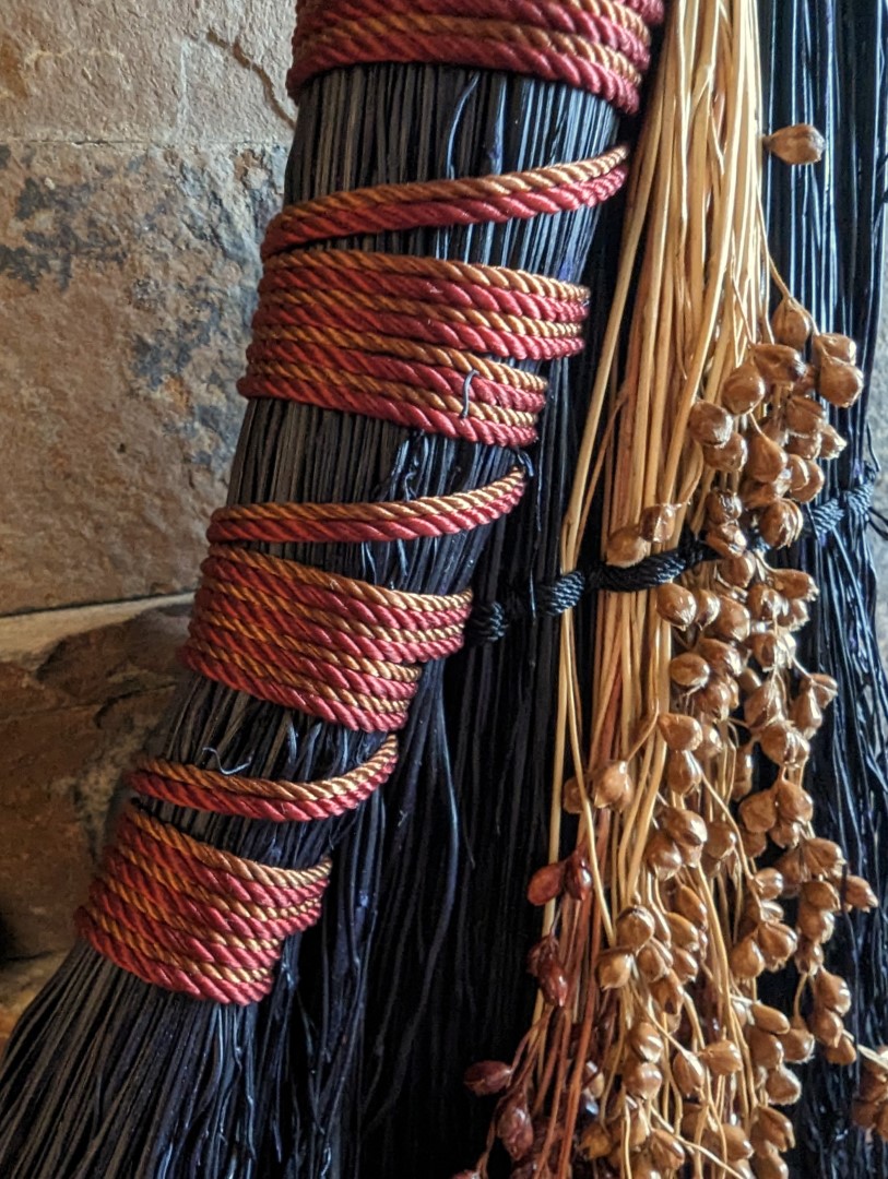Brick Red and Terra Cotta colored cording. There are dark red and brown broomcorn seeds woven in. 